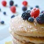 Coconut Milk Pancakes Topped with Maple Syrup and Berries