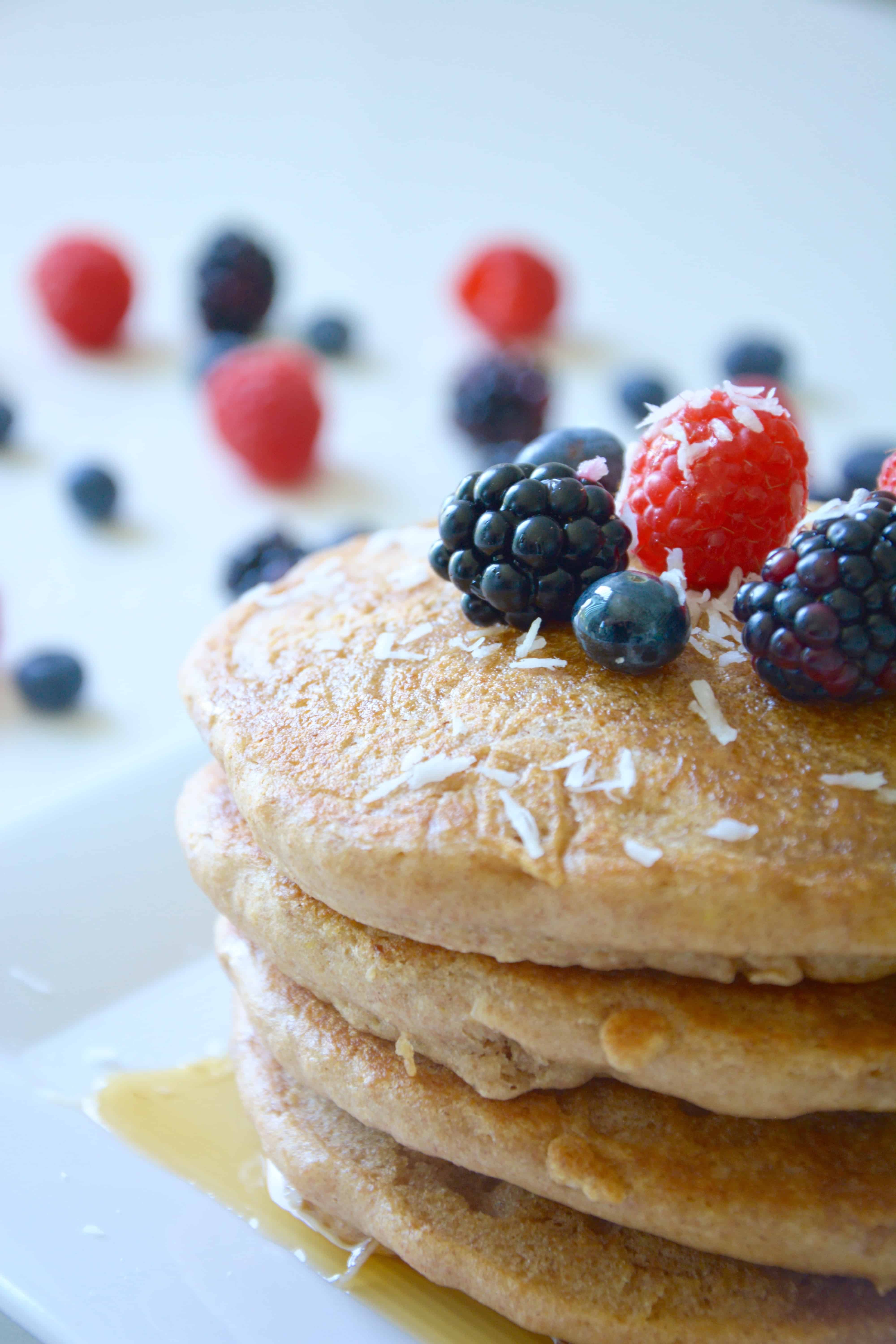 Coconut Milk Pancakes Topped with Maple Syrup and Berries - Pralines and  Greens